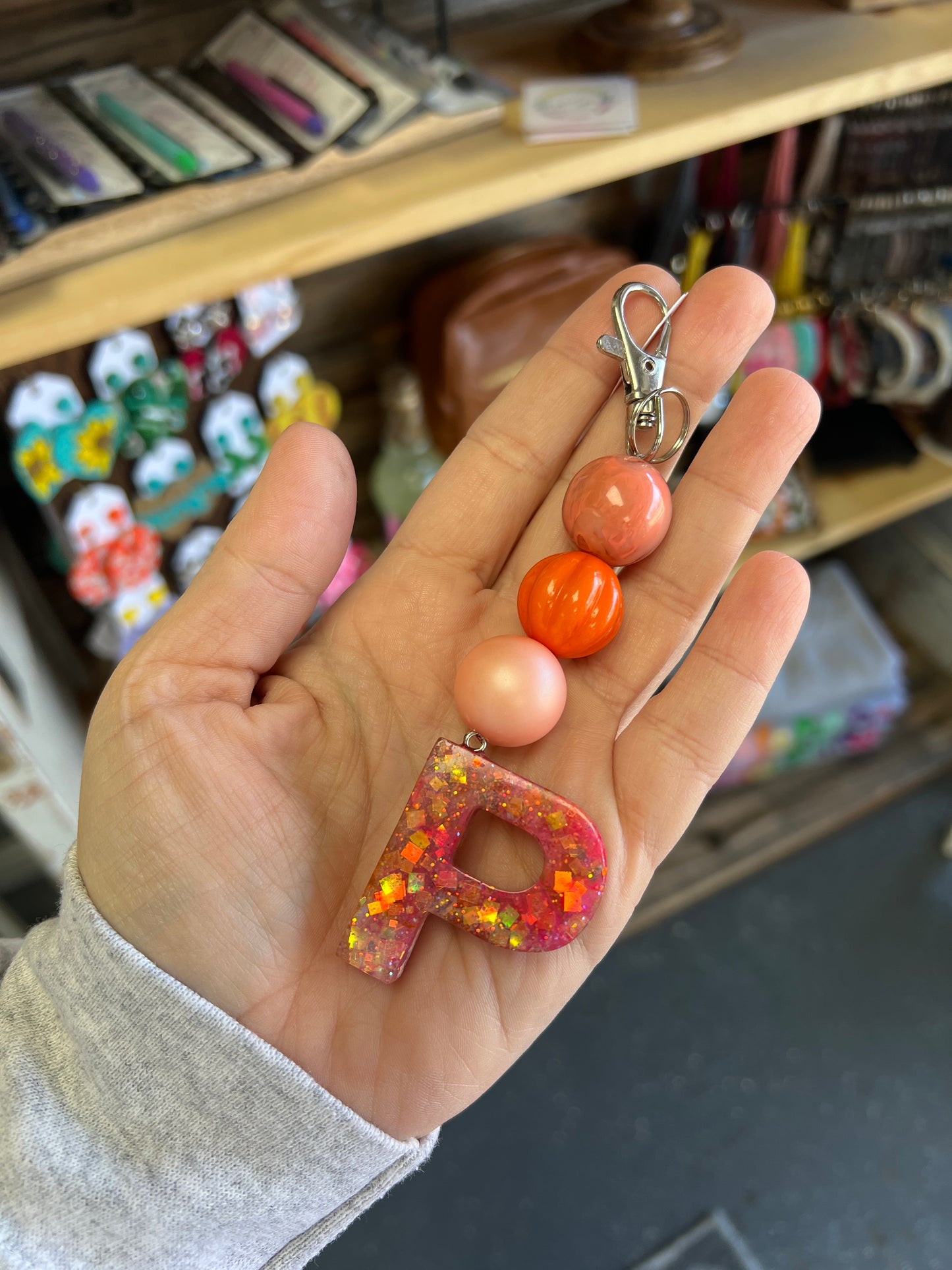 Keychain - orange swirl, orange pumpkin, coral pearl beads w/ orange chunky glitter P