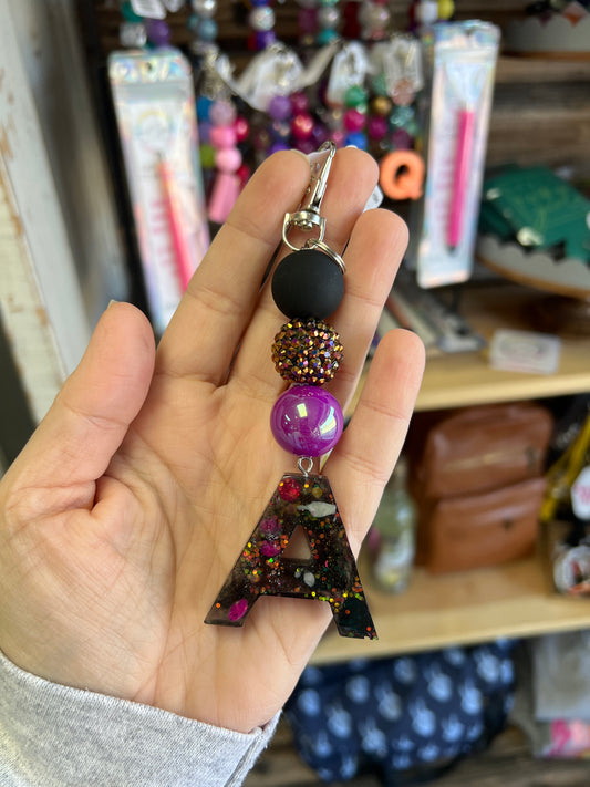 Keychain - matte black, gold irridescent rhinestone, irridescent purple beads w/ black,purple, glitter A